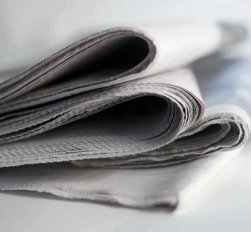 Stack of folded newspapers.